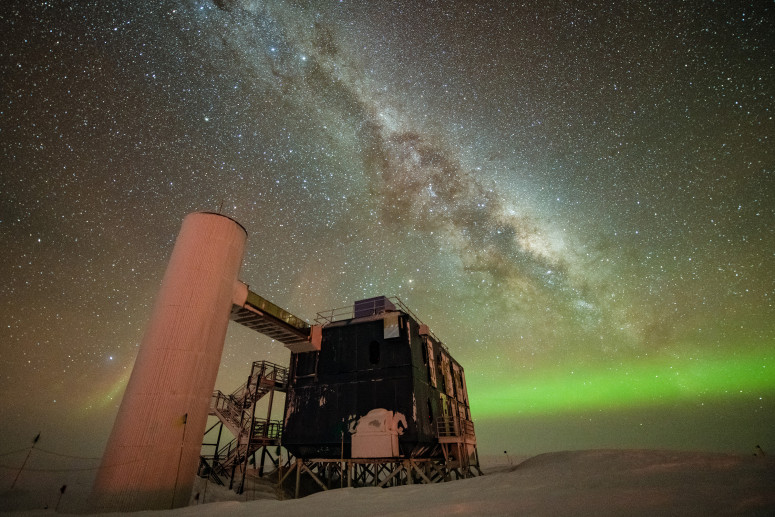 This image shows a visual representation of one of the highest-energy neutrino detections superimposed on a view of the IceCube Lab at the South Pole. Credit: IceCube Collaboration
