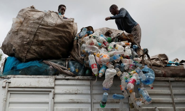Workers in Nairobi unload plastic bottles for recycling.