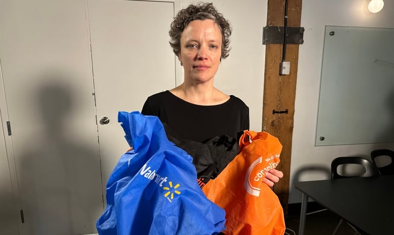 Emily Alfred holds two reusable bags.