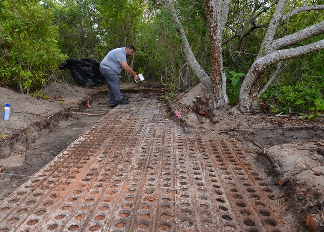 University of South Florida 3D applications engineer Jorge Gonzalez aims a structured light scanner at the recently unearthed Marston Pad entrance walkway leading to the Bumper bunker at Cape Canaveral Space Force Station.