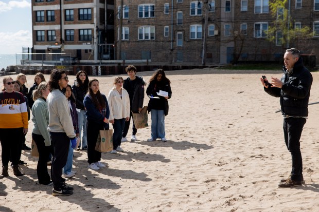 Loyola University professor Tim Hoellein speaks after collecting trash from students at Hartigan Beach in Chicago on April 20, 2024. Students earned extra credit in Holland's ecology class for participating in the cleanup.  (Vincent Alban/Chicago Tribune)