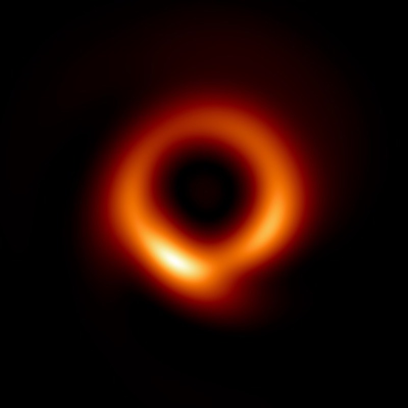 Glowing red, orange and yellow shaped rings with a large black center on a black background.