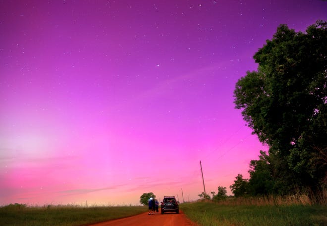 People watch the Northern Lights near Cashion, Oklahoma, Friday, May 10, 2024.