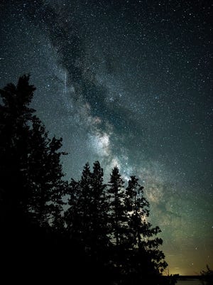In this photo from the summer of 2016, the Milky Way is visible above the old-growth forest at Mackinac Headlands International Dark Sky Park.